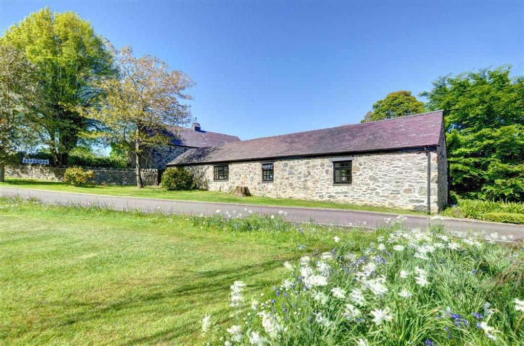 an old stone house on the side of a road at 2 Bed in Menai Bridge oc-fl046 in Llandegfan