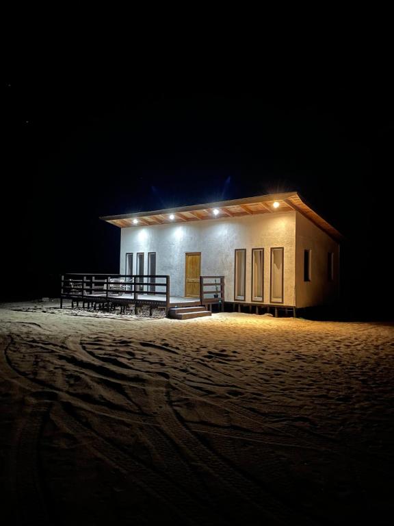 a small building with lights on it at night at Rincon del desierto lodge in Punta de Choros