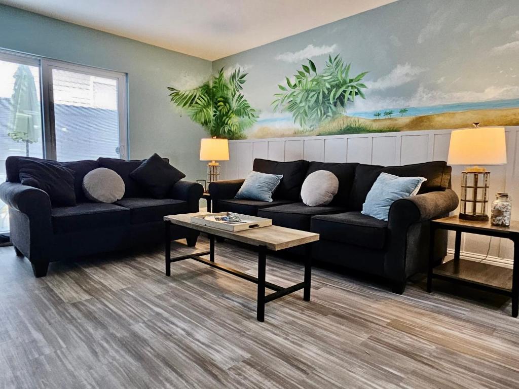 a living room with two couches and a coffee table at Seaside Gem in Biloxi