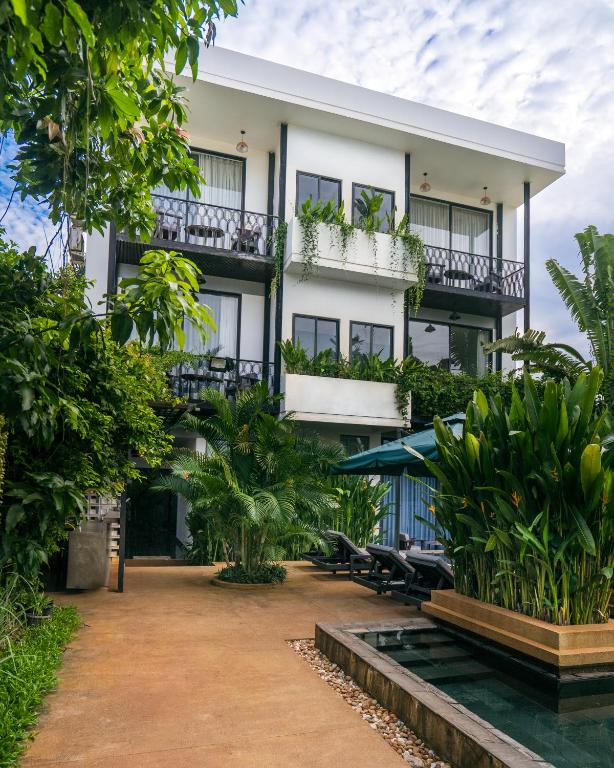 an exterior view of a building with plants at Villa Sun - Boutique Hotel in Siem Reap