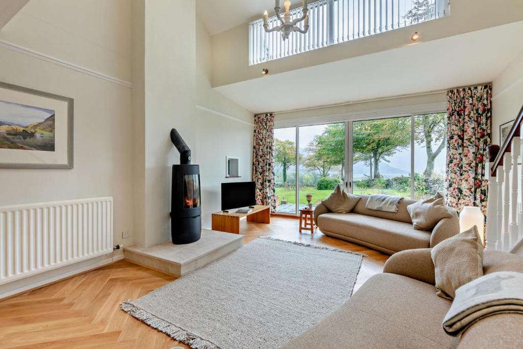 a living room with a couch and a fireplace at 3 Bed in Loweswater oc-w30224 in Loweswater