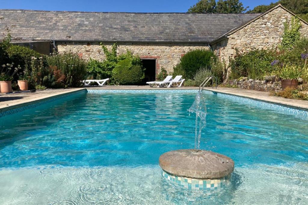 a swimming pool with a fountain in the middle at 3 Bed in Chale oc-s30298 in Chale