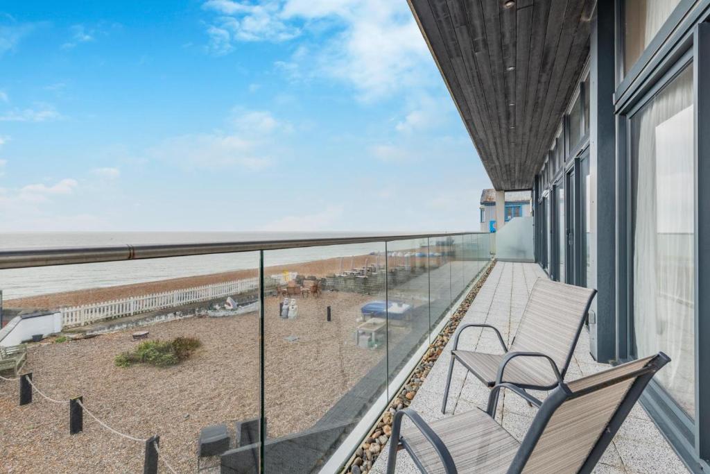 a balcony with chairs and a view of the beach at 4 Bed in Hythe oc-p30519 in Hythe