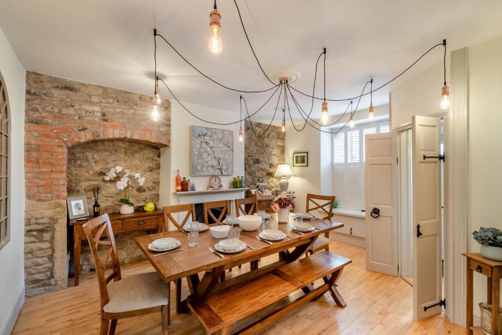 a dining room with a table and a brick wall at 4 Bed in Alnwick oc-g32272 in Alnwick