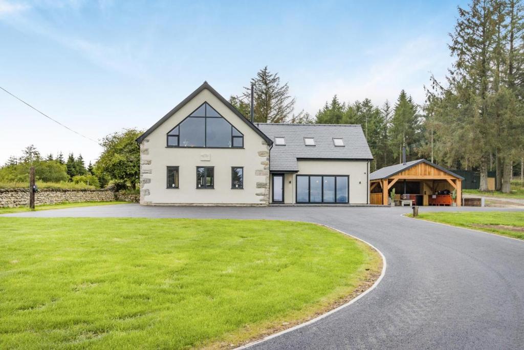 a large white house with a driveway at 5 Bed in Cyffylliog oc-c32596 in Cyffylliog
