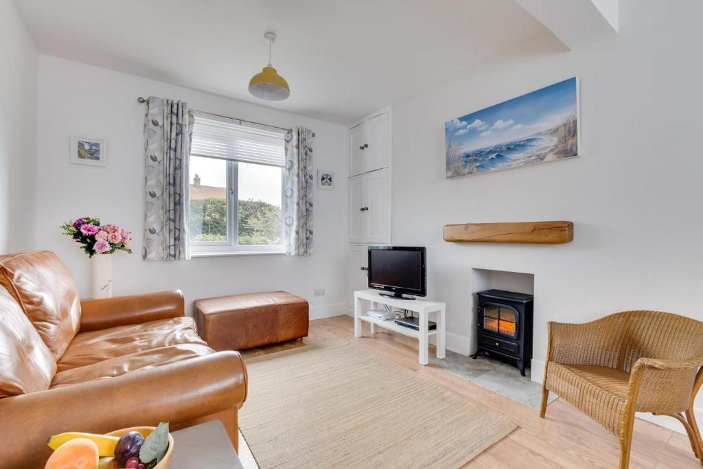 a living room with a couch and a fireplace at 1 Bed in Seahouses oc-gd1735 in Seahouses