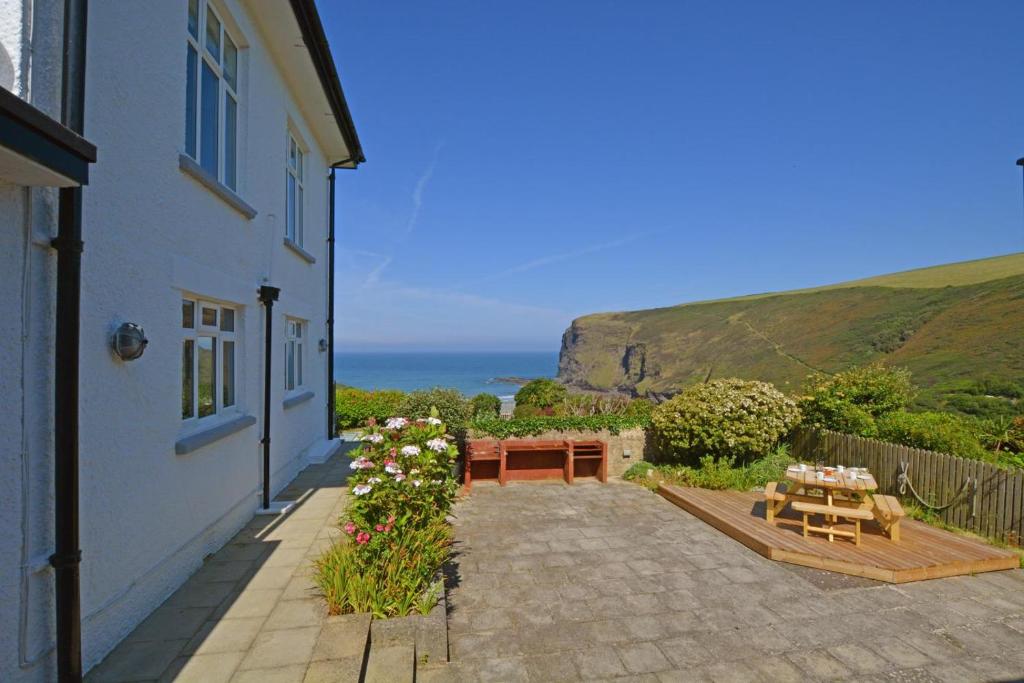 a house with a patio with a view of the ocean at 2 Bed in Crackington Haven oc-p00596 in Crackington Haven