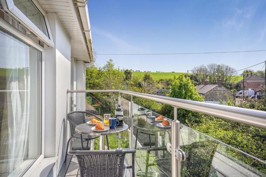 a balcony with a table and chairs and a view at 3 Bed in West Lulworth oc-h29362 in West Lulworth