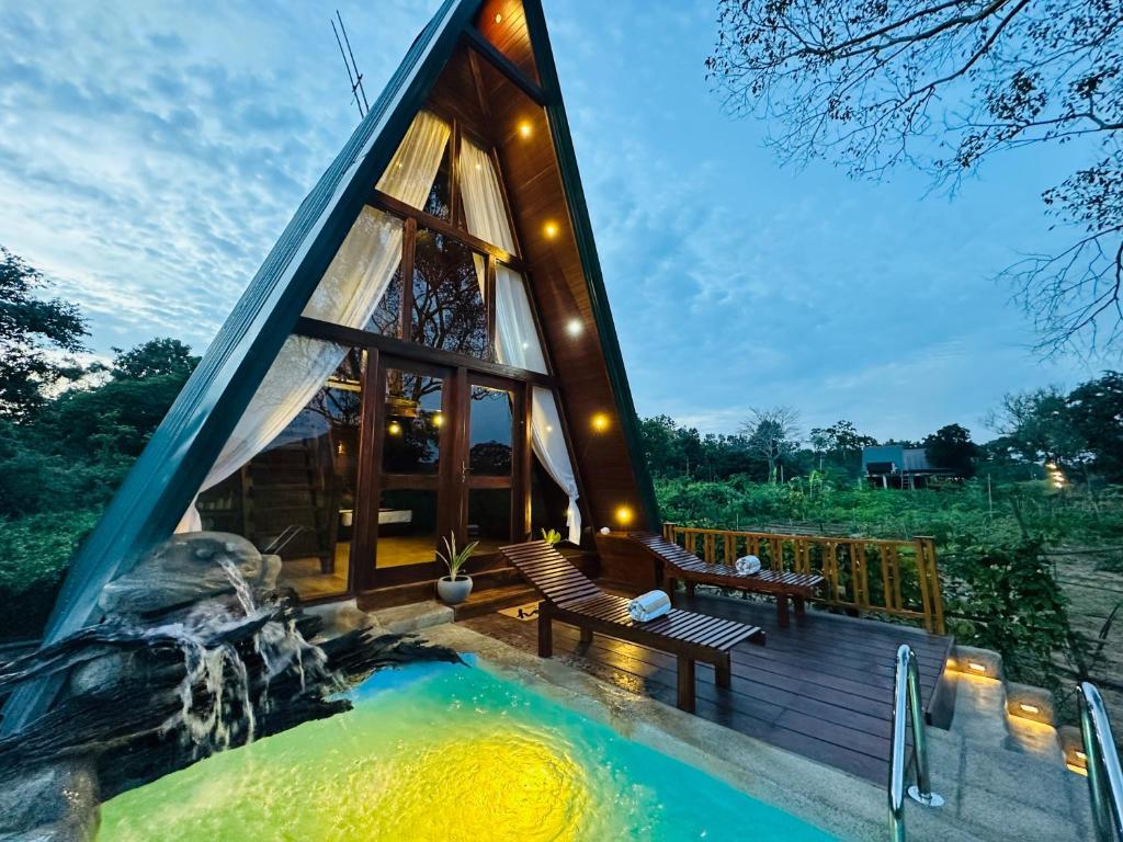 a tiny house with a hot tub in the backyard at The Classic Crown Sigiriya in Sigiriya