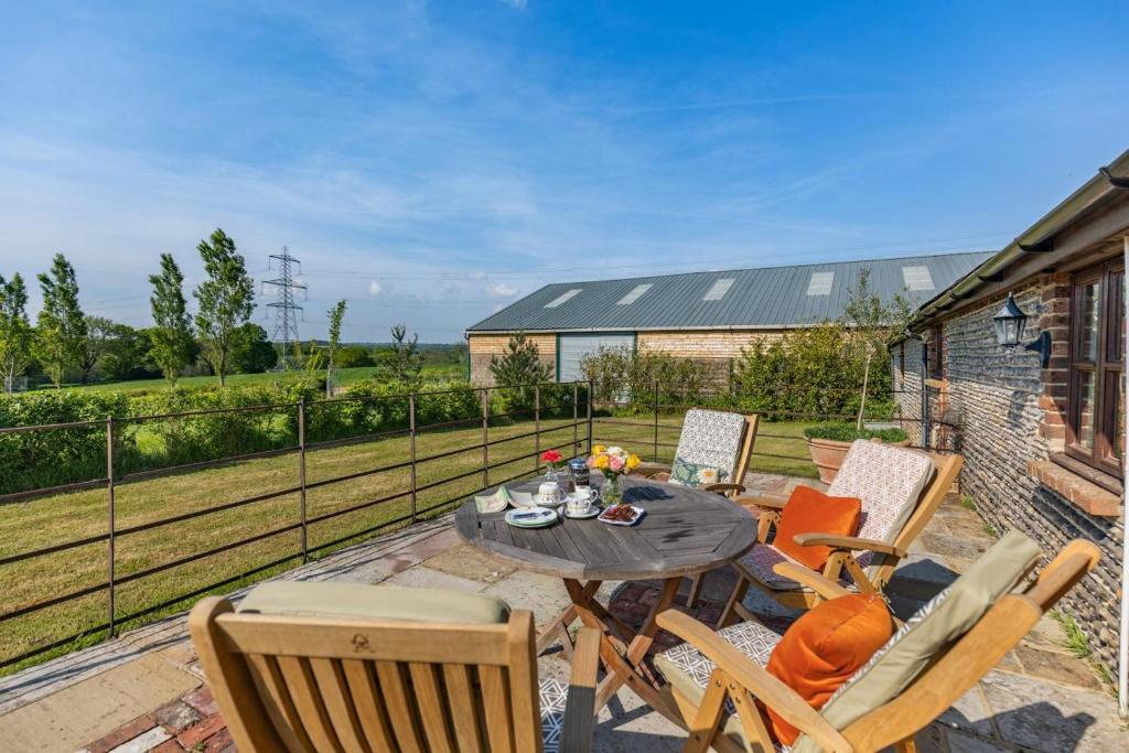 a patio with a table and chairs on a balcony at 2 Bed in Hellingly oc-b29393 in Warbleton