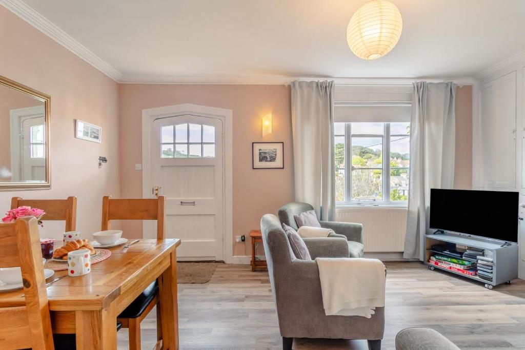 a living room with a table and a tv at 3 Bed in Beer oc-b31132 in Beer