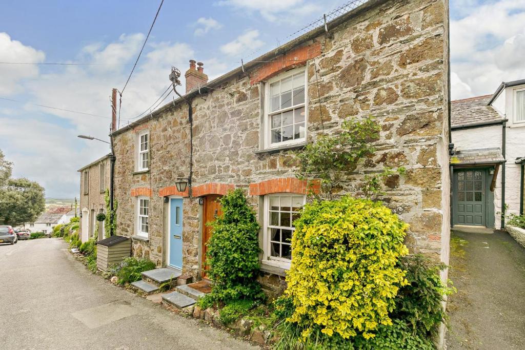 a stone house with a blue door on a street at 2 Bed in St. Minver oc-p27580 in Saint Minver