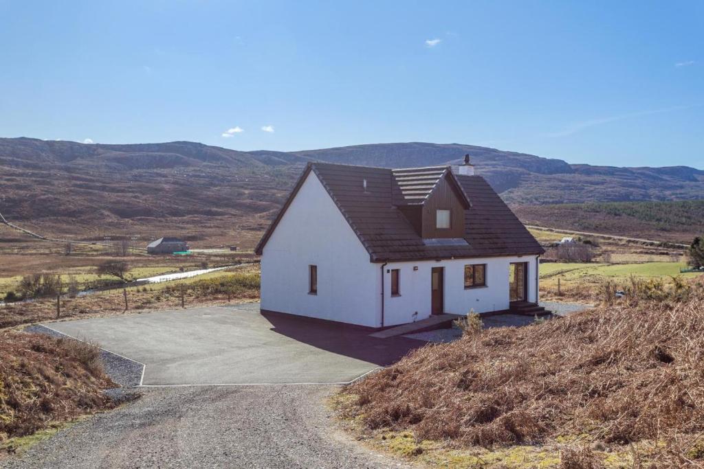 a white house on top of a hill at 3 Bed in Strathkanaird oc-r30948 in Ullapool