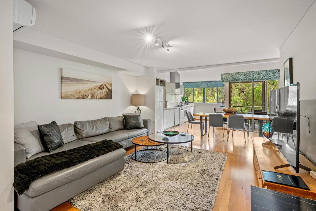 a living room with a couch and a table at Apt 9 'Delphinius' @ Bay View Centro, Dunsborough in Dunsborough