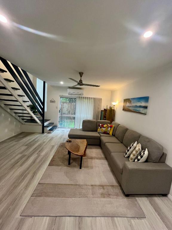 a living room with a couch and a table at The Lazy Break at Trinity in Trinity Beach