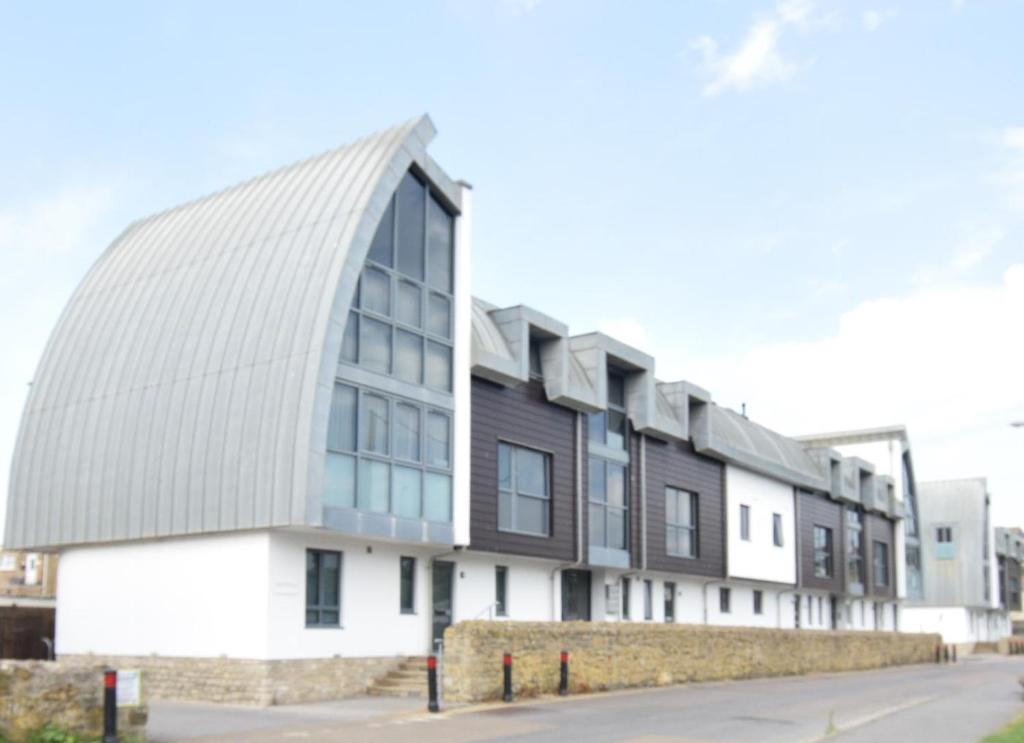 a building with a pointed roof on a street at 2 Bed in West Bay oc-d31037 in West Bay