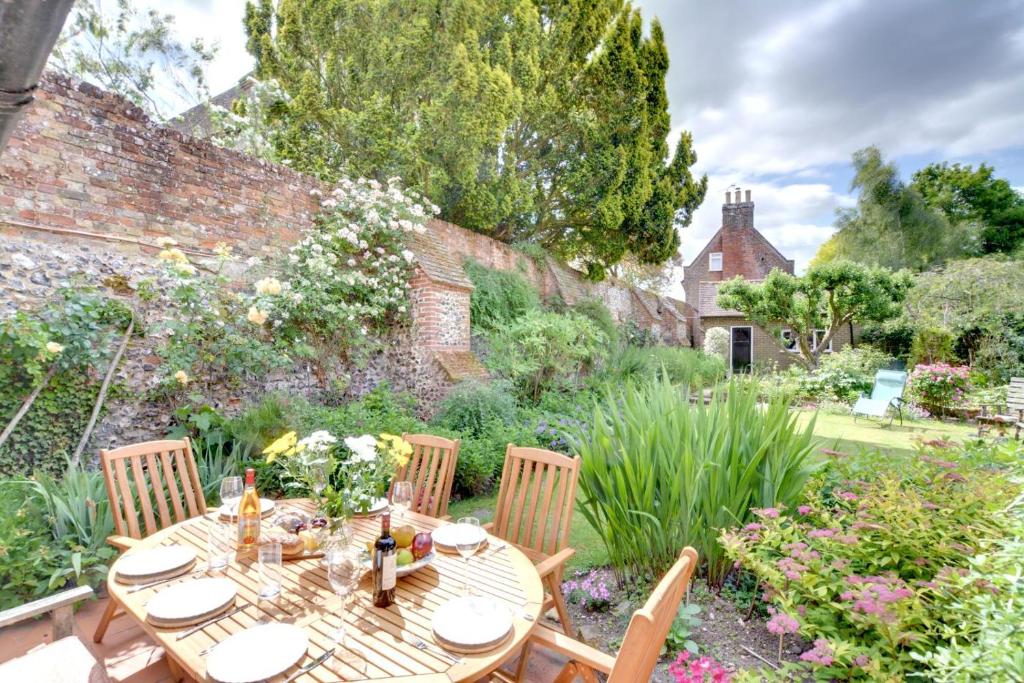 a wooden table and chairs in a garden at 4 Bed in Barham oc-ct016 in Barham