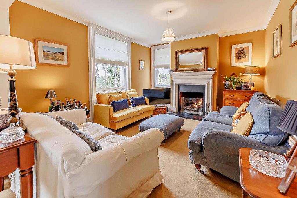 a living room with two couches and a fireplace at 5 Bed in Sedlescombe oc-l27505 in Sedlescombe