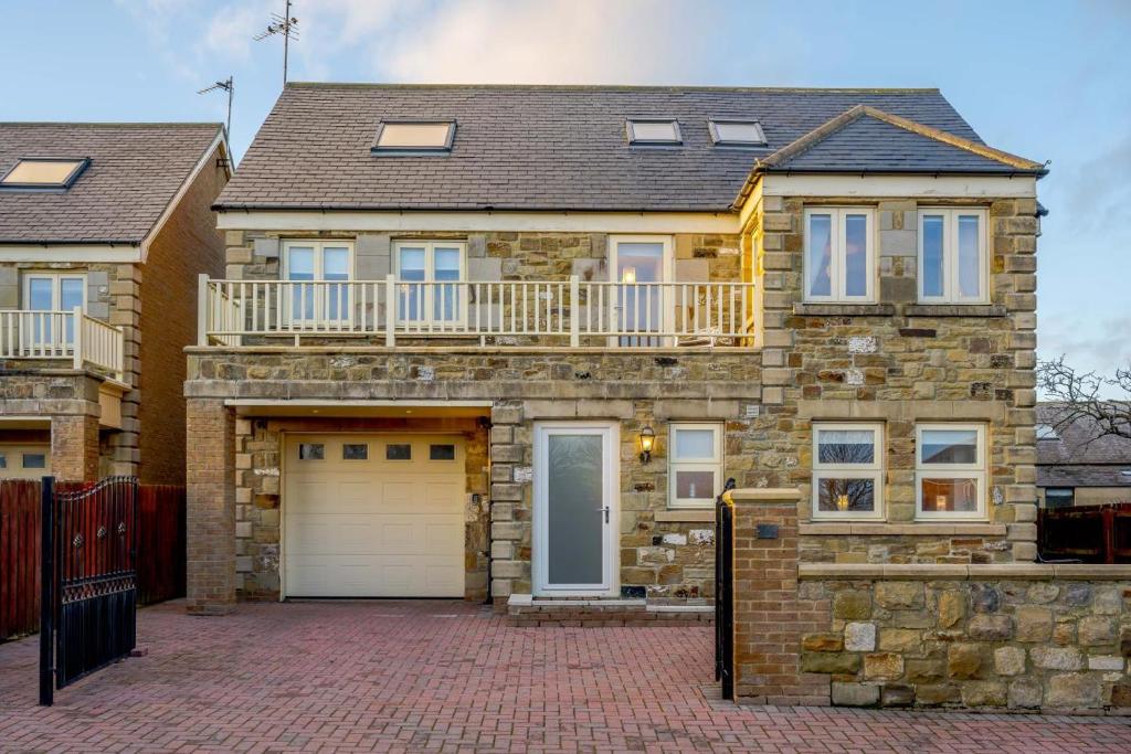 a large brick house with a white garage at 4 Bed in North Sunderland oc-gd1890 in North Sunderland