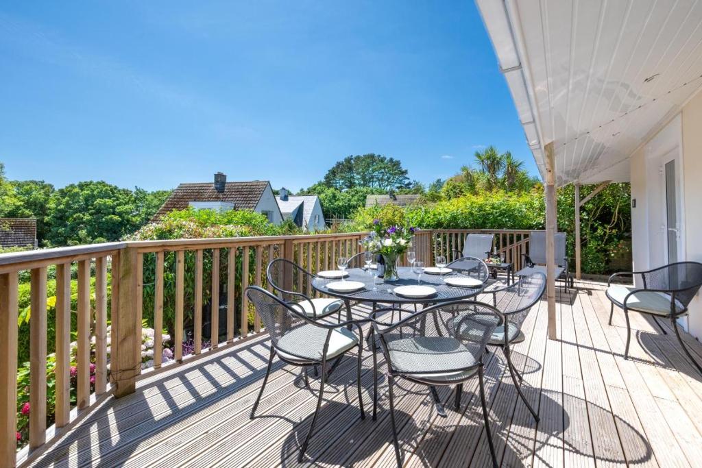 a patio with a table and chairs on a deck at 3 Bed in Fowey oc-p00755 in Fowey