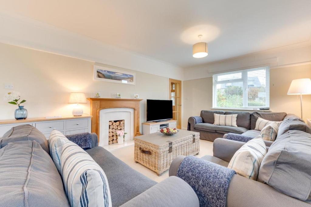 a living room with a couch and a fireplace at 4 Bed in Langton Matravers oc-wy548 in Langton Matravers