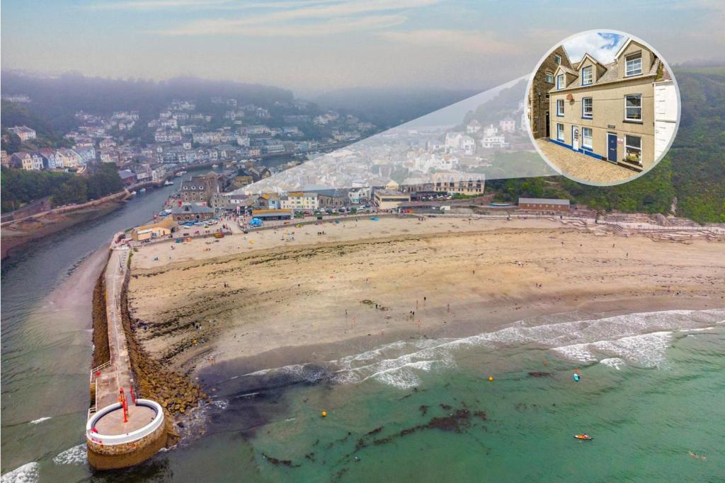 an aerial view of a beach with a building at 2 Bed in Looe oc-a29612 in Looe