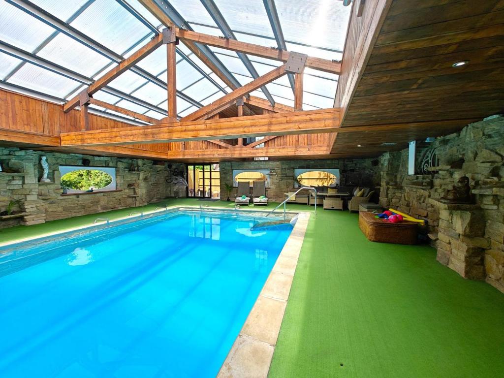 a large swimming pool in a building with a glass ceiling at 3 Bed in Timsbury oc-h29584 in Timsbury