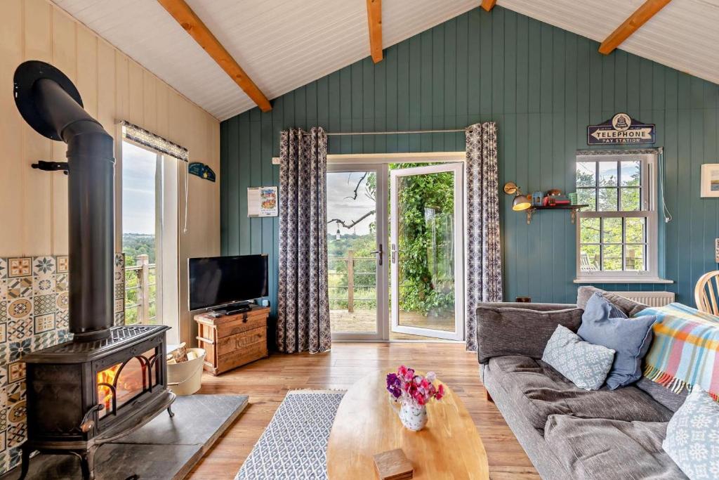 a living room with a couch and a wood stove at 1 Bed in Dre-Fach Felindre oc-a29876 in Felindre