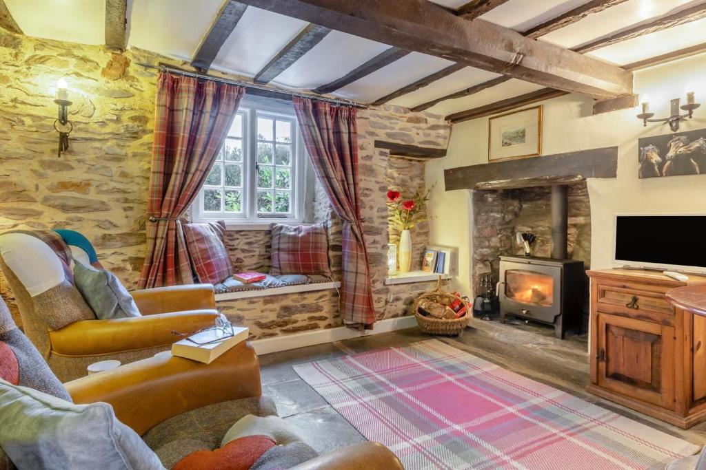 a living room with a fireplace and a tv at 1 Bed in Dulverton oc-l30886 in Dulverton