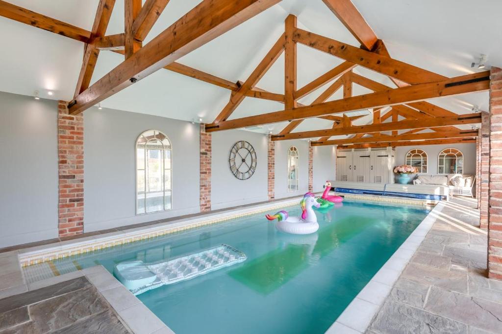 a swimming pool in a house with wooden beams at 5 Bed in Haceby oc-c31061 in Haceby