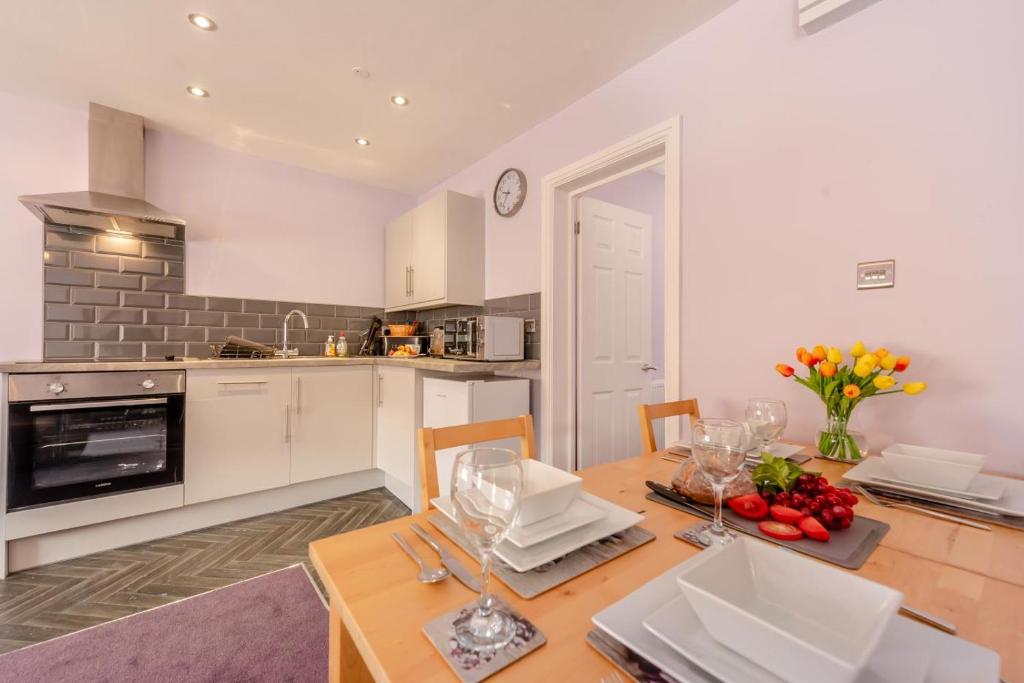 a kitchen with a wooden table and a dining room at 2 Bed in Tenby oc-w28985 in Tenby