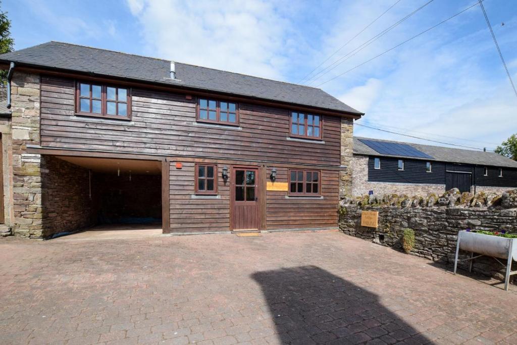 a large wooden barn with a garage at 1 Bed in Dorstone oc-c31765 in Dorstone