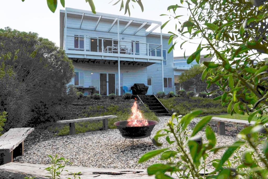 a fire pit in front of a house at Beach by the Dunes in Goolwa South