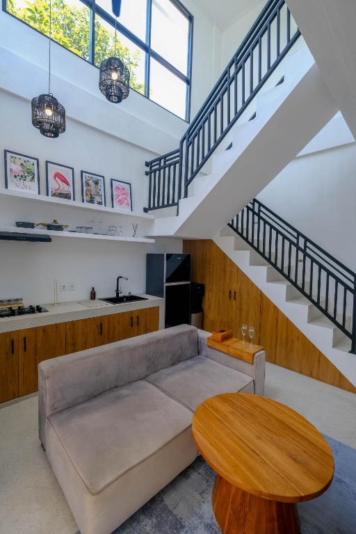 a living room with a couch and a table at Virgo Sun House in Uluwatu