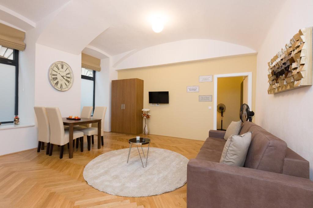 a living room with a couch and a table at Vienna Stay Apartments Belvedere in Vienna
