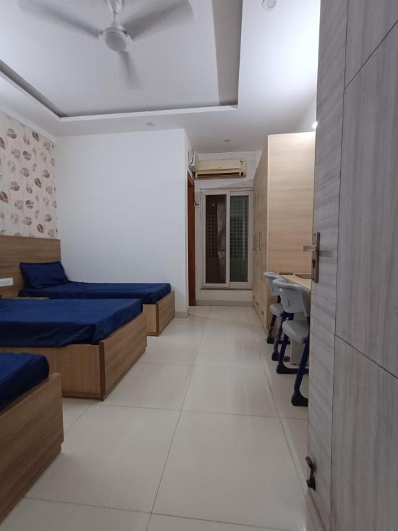 a hospital room with two beds and a desk at The Elite Ambience Hotel in Greater Noida