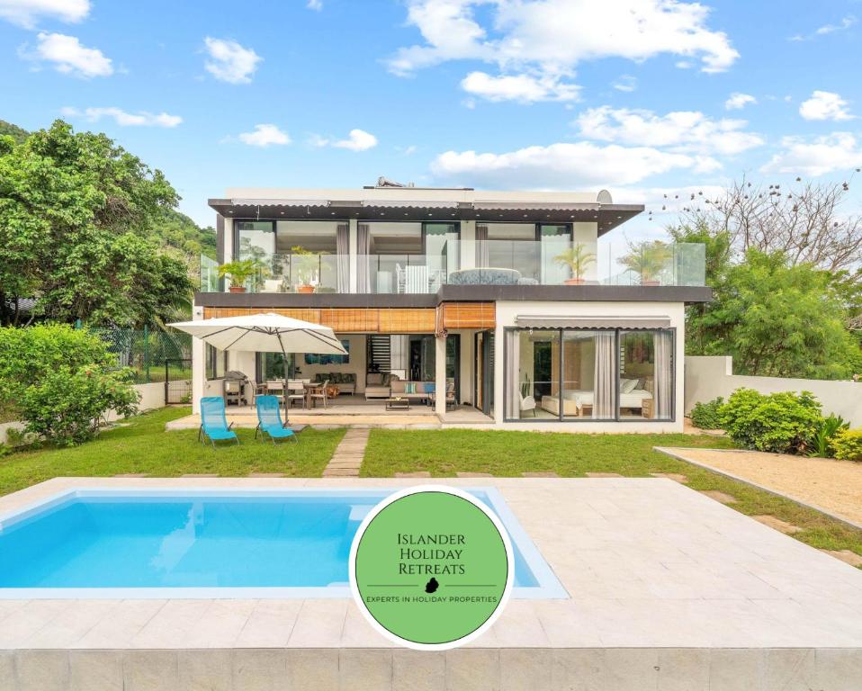 a house with a swimming pool in front of it at Sublima Villa, Luxe et élégance in La Gaulette