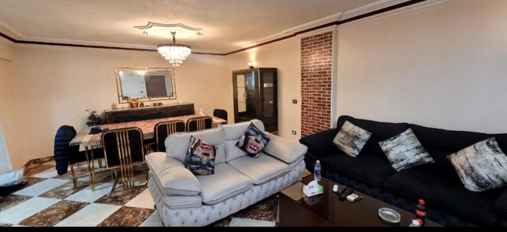 a living room with a couch and a table at Sheraton Apartment شقة الشيراتون in Cairo