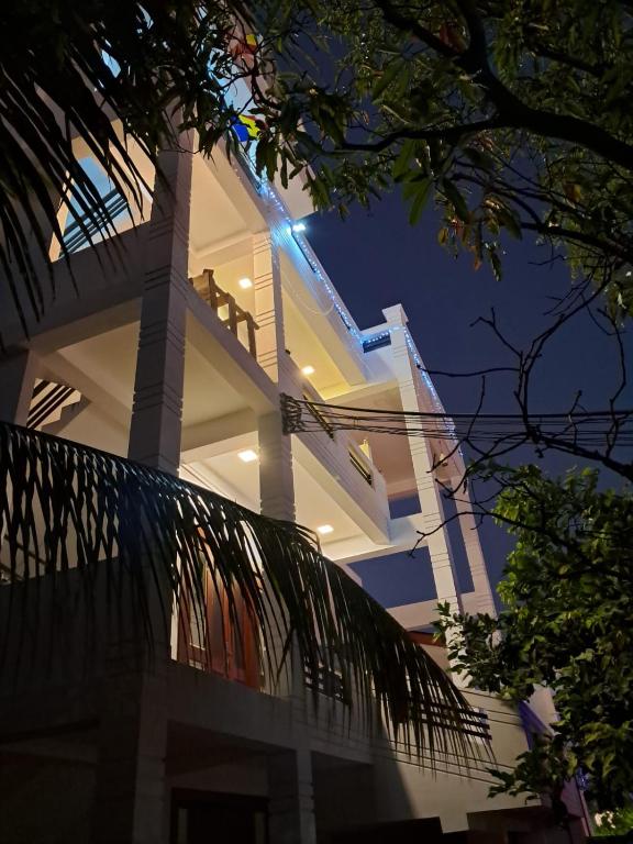 a white building with a light on it at night at Sky Glow Residence in Pepiliyana
