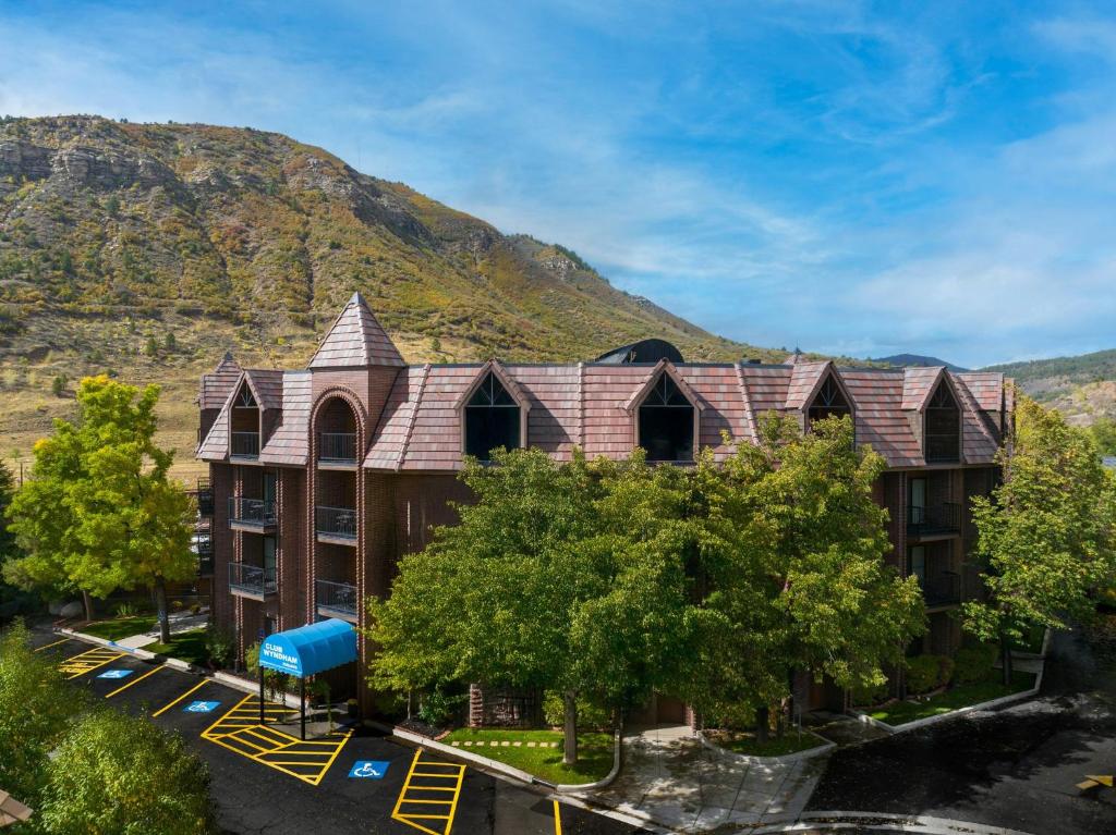 an apartment building with a mountain in the background at Club Wyndham Durango in Durango