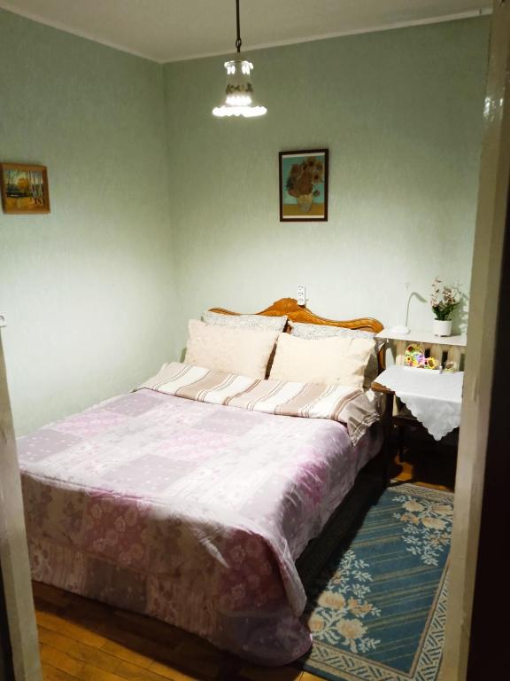 a bedroom with a large bed and a table at apartment Galitskaya Square in Kyiv