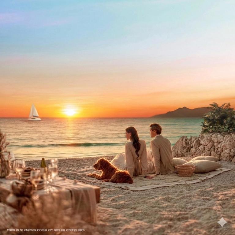 two people and a dog sitting on the beach at sunset at Wellness Resort Rayong Managed by SCN in Ban Huai Pla Kang