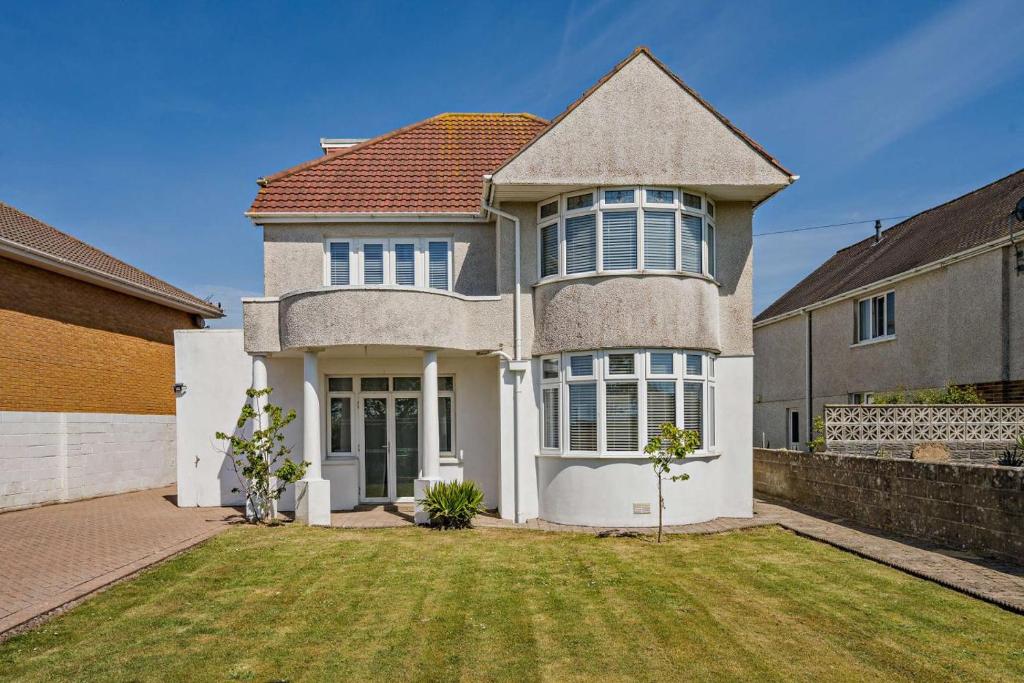 a large brick house with a red roof at 4 Bed in Nottage oc-a32048 in Nottage