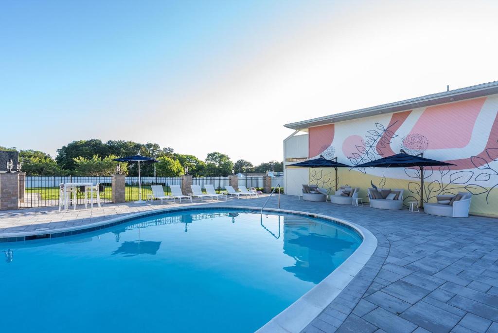 a swimming pool in front of a building at The Bentley Hotel Southampton in Southampton