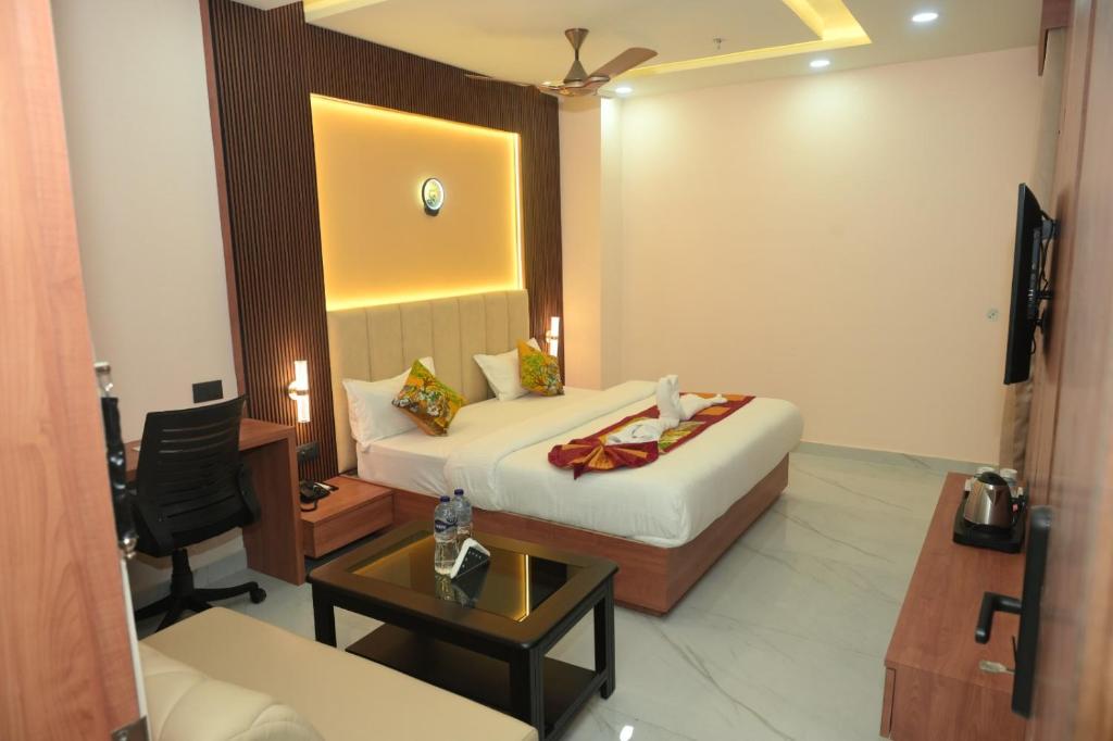 a hotel room with a bed and a desk at Hotel Elite Suites in Padrauna