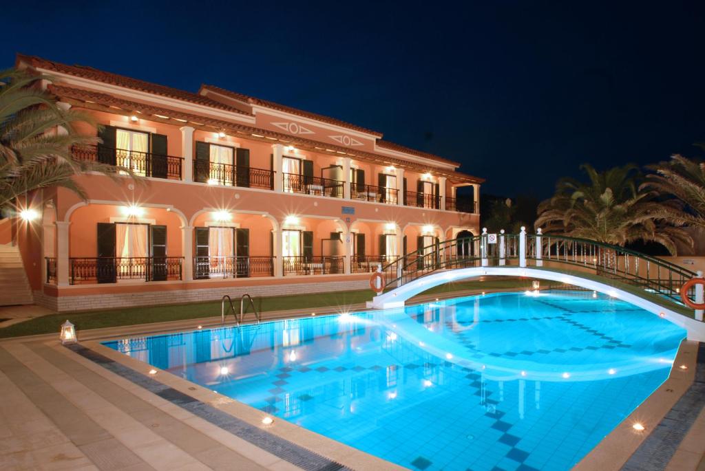 
a large swimming pool in a large building at Dimitris Apartments in Sidari

