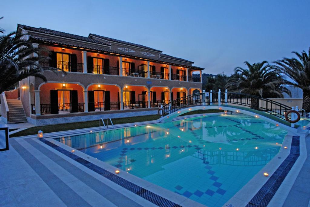 a large swimming pool in front of a building at Dimitris Apartments in Sidari