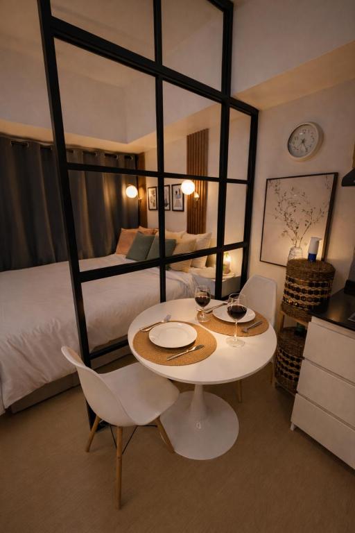 a room with a table and chairs and a bed at Vinyce Studio in Cagayan de Oro