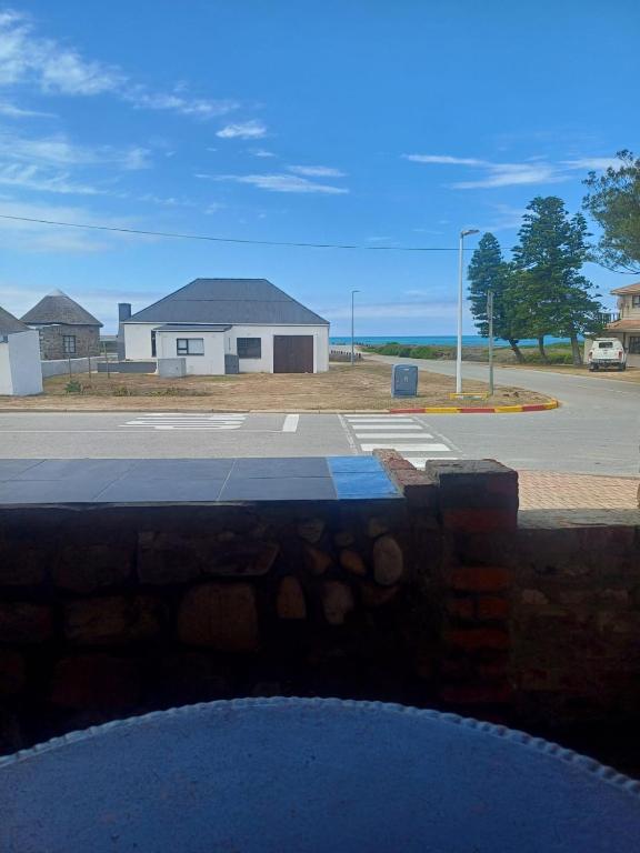 a view of a parking lot with a house at Gouritsmond Self Catering Units in Gouritzmond