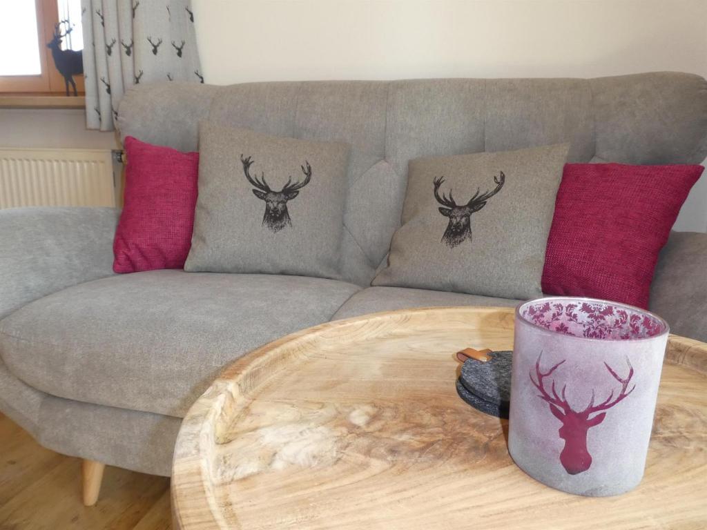 a living room with a couch and a coffee table at Gästehaus Bergblick in Wallgau